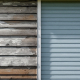 A photograph of a home with visibly outdated siding materials