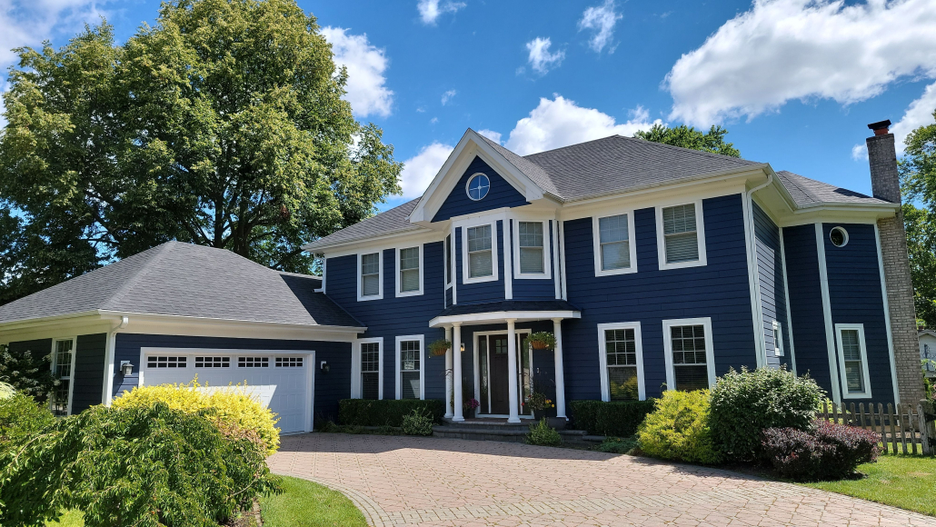 Arlington Heights home after premium exterior renovation: New GAF roof, Deep Ocean James Hardie siding, and seamless gutters by Revived Exteriors.